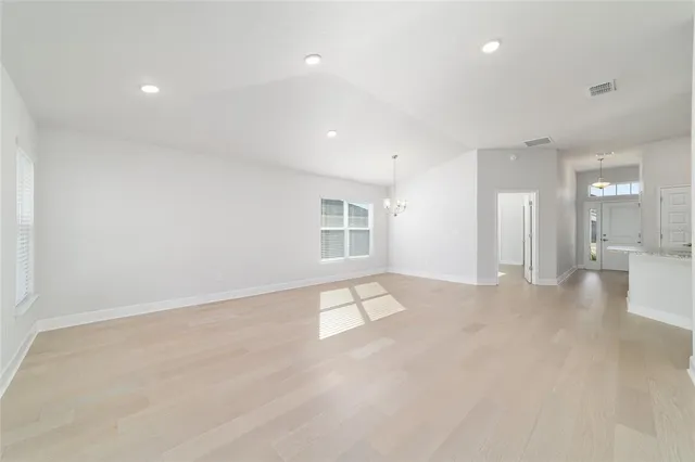 a kitchen with stainless steel appliances granite countertop a sink refrigerator and cabinets