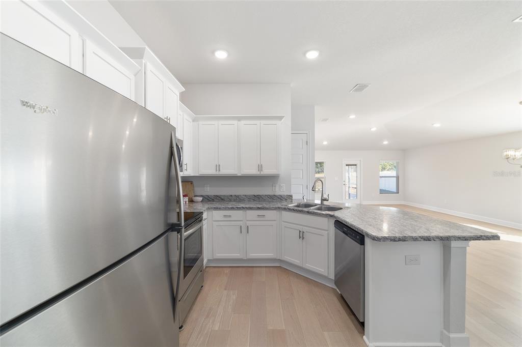 4373 Northeast 31st Street Ocala, FL 34470 - Photo 20 of 51 a kitchen with stainless steel appliances granite countertop refrigerator sink and cabinets
