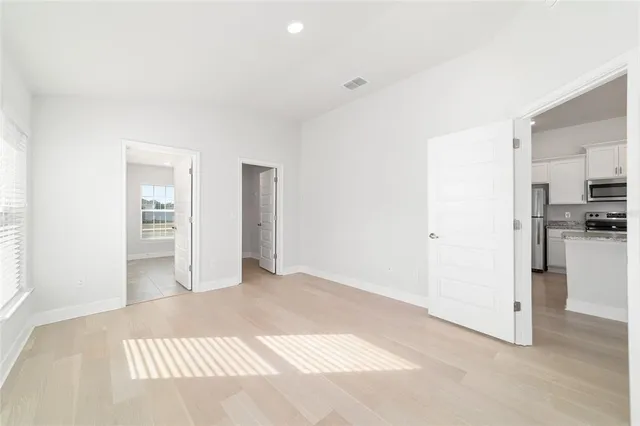 a bathroom with a granite countertop sink mirror and a toilet
