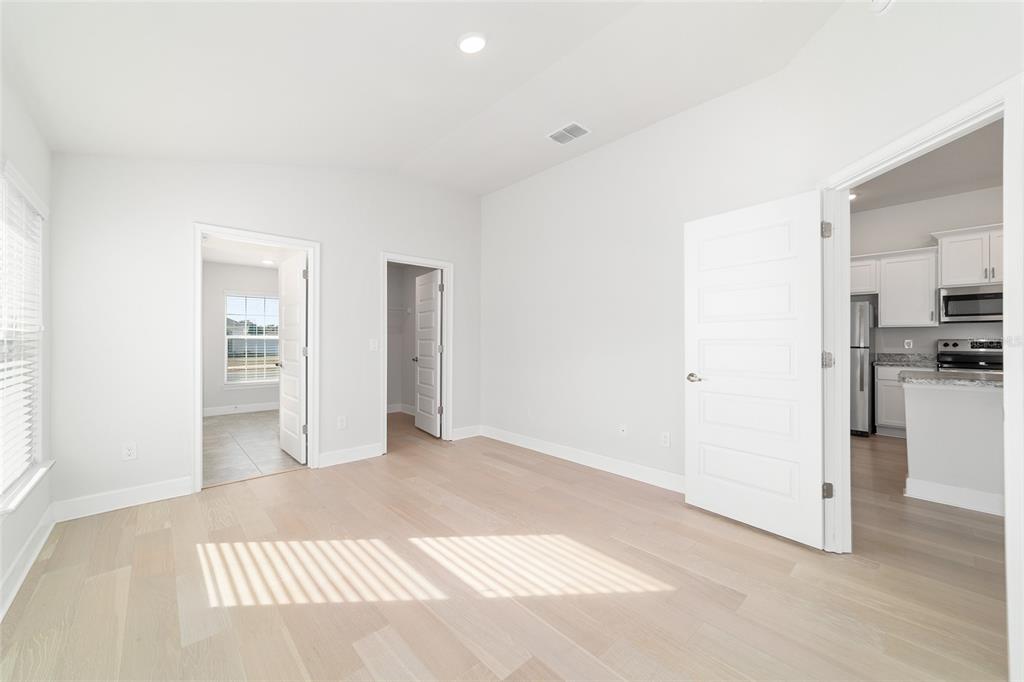 4373 Northeast 31st Street Ocala, FL 34470 - Photo 23 of 51 a view of a livingroom with wooden floor and kitchen space