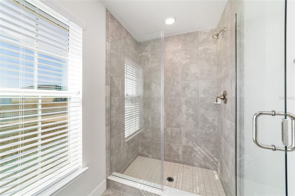 4373 Northeast 31st Street Ocala, FL 34470 - Photo 27 of 51 a bathroom with a shower and a window
