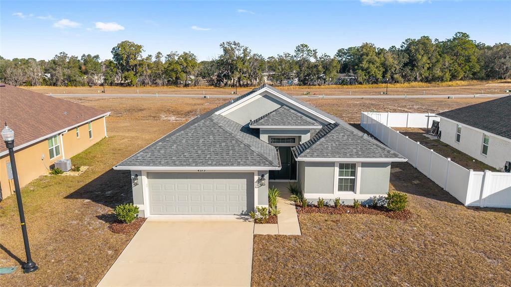 4373 Northeast 31st Street Ocala, FL 34470 - Photo 3 of 51 a front view of a house with a yard and garage