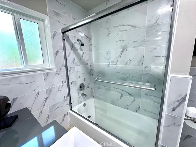 a bathroom with a bathtub and a shower