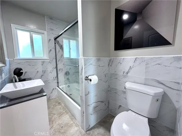 a bathroom with a sink a toilet and bathtub
