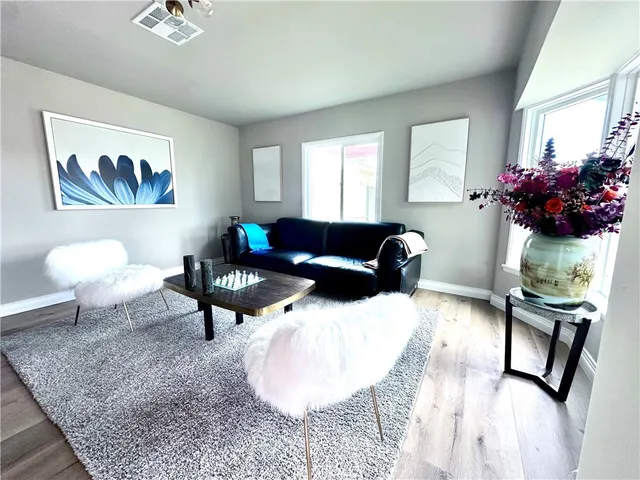 a living room with furniture and a potted plant