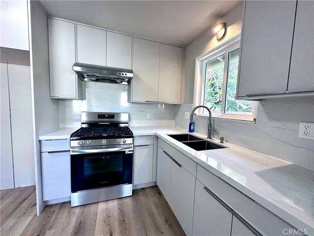 a kitchen with a stove and a sink