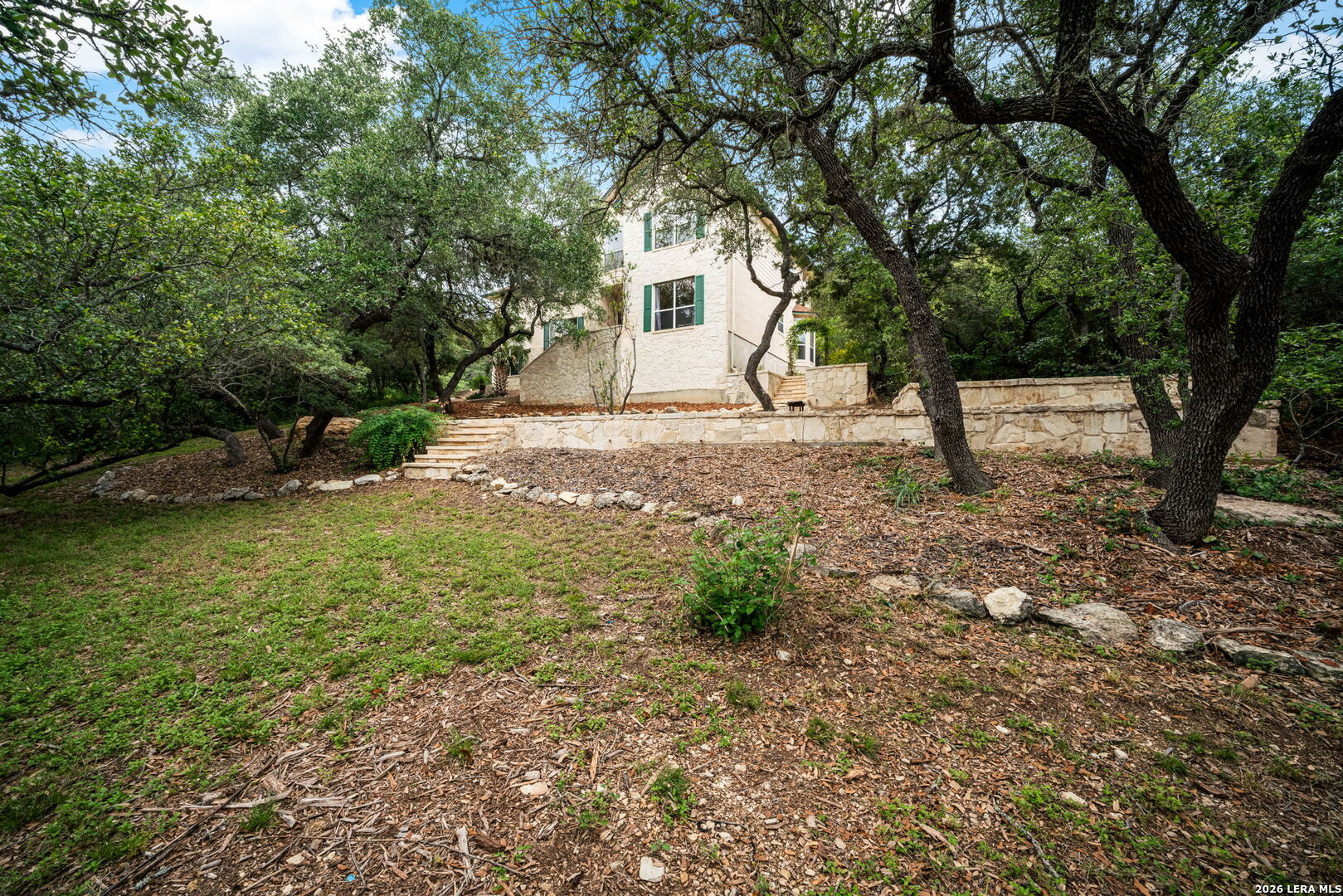 17431 Helotes Spring Road Helotes, TX 78023 - Photo 4 of 50 a backyard of a house with lots of green space