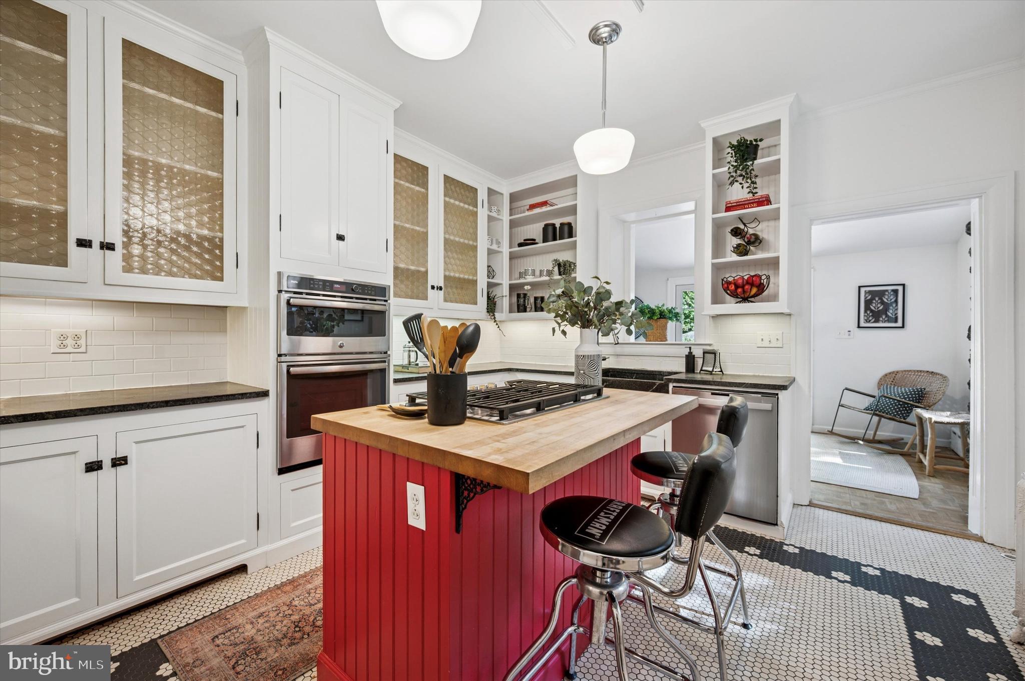 200 East Gravers Lane Philadelphia, PA 19118 - Photo 15 of 57 a kitchen with stainless steel appliances granite countertop a stove a sink dishwasher a dining table and chairs with wooden floor