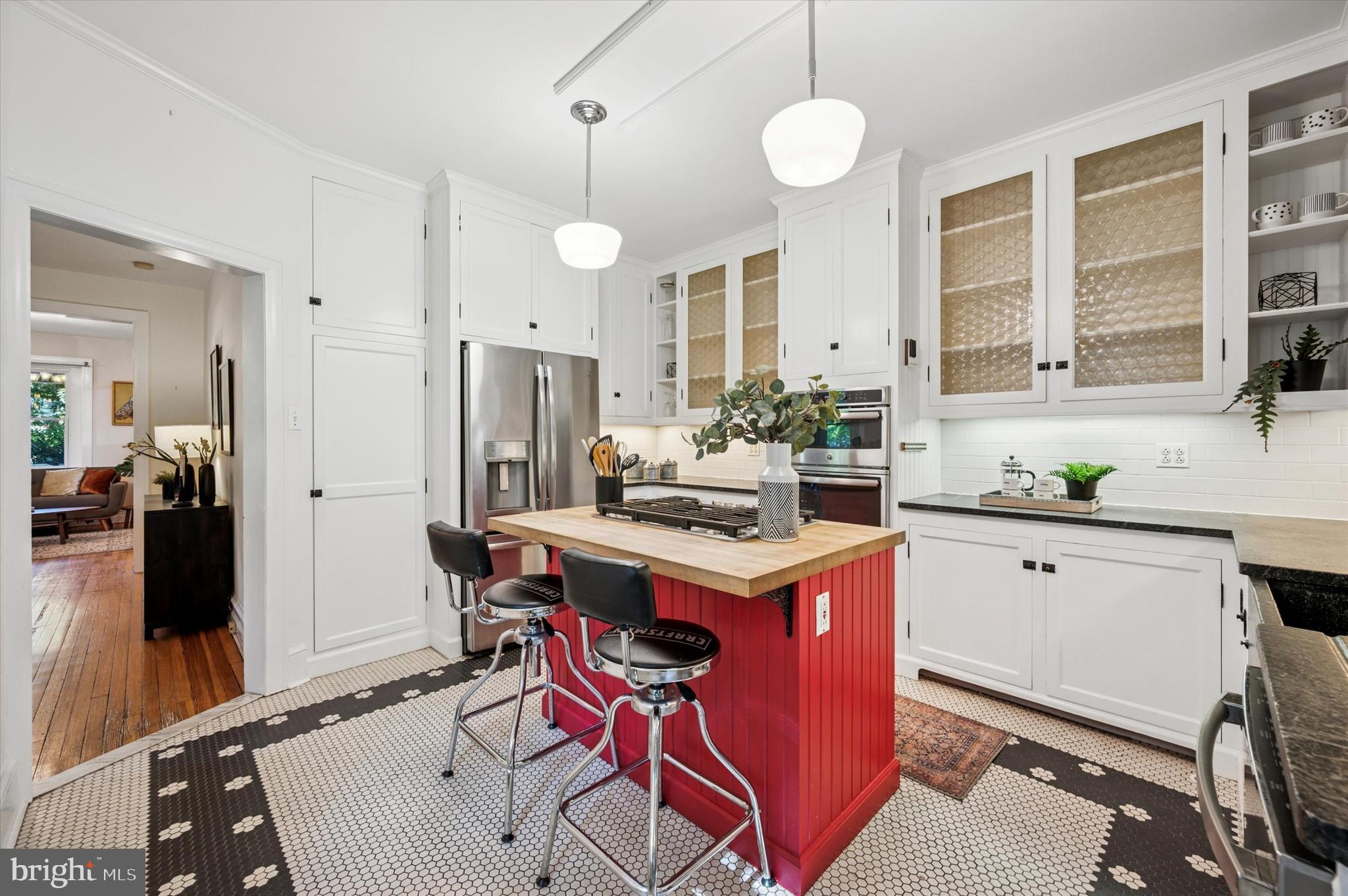 200 East Gravers Lane Philadelphia, PA 19118 - Photo 16 of 57 a kitchen with a stove a refrigerator and a dining table