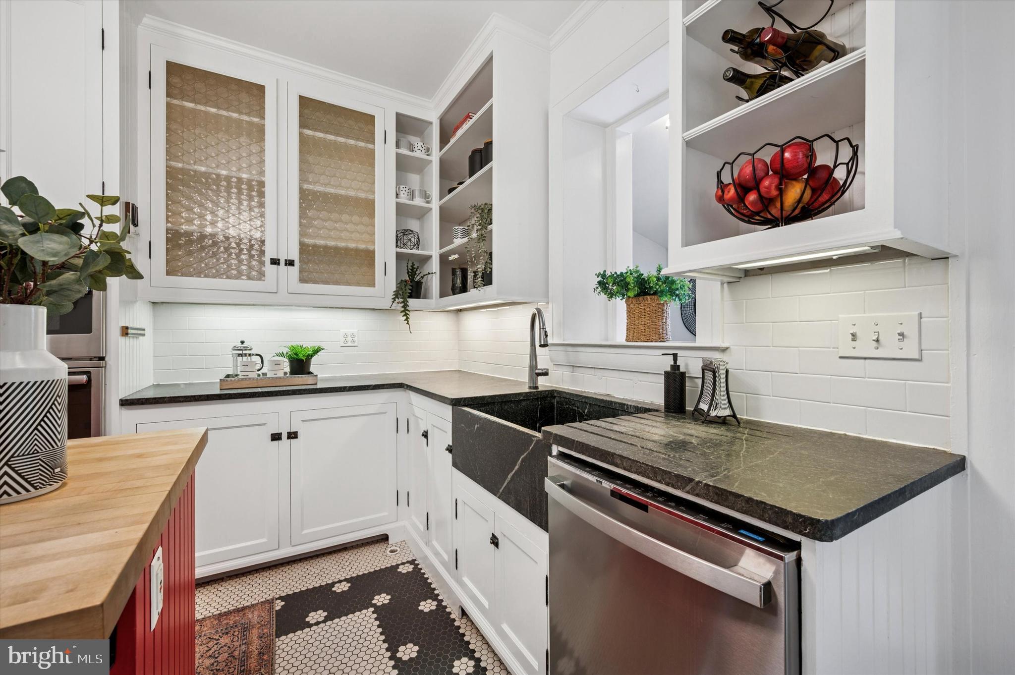 200 East Gravers Lane Philadelphia, PA 19118 - Photo 17 of 57 a kitchen with stainless steel appliances granite countertop a sink a stove and white cabinets