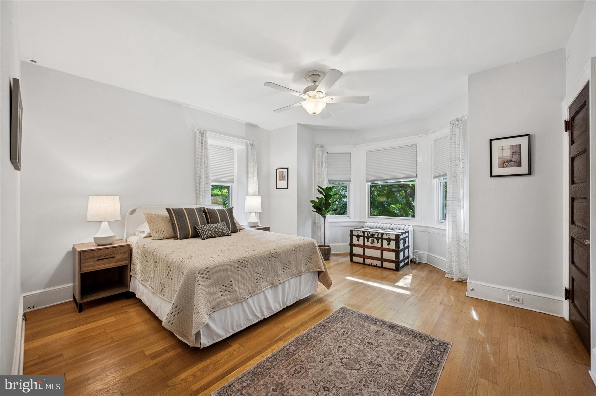 200 East Gravers Lane Philadelphia, PA 19118 - Photo 32 of 57 a bedroom with a bed wooden floor and window