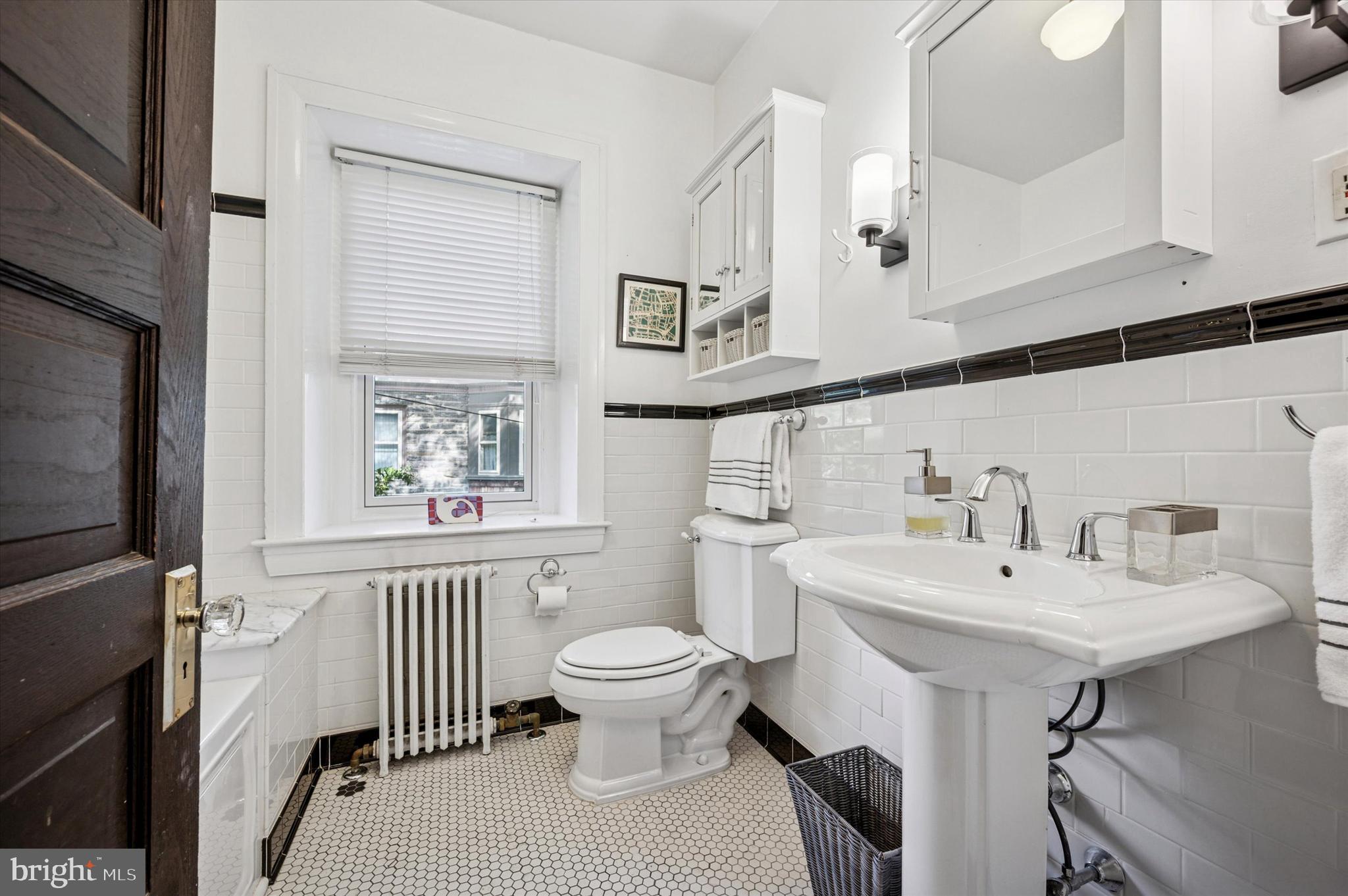 200 East Gravers Lane Philadelphia, PA 19118 - Photo 34 of 57 a bathroom with a sink toilet and a mirror