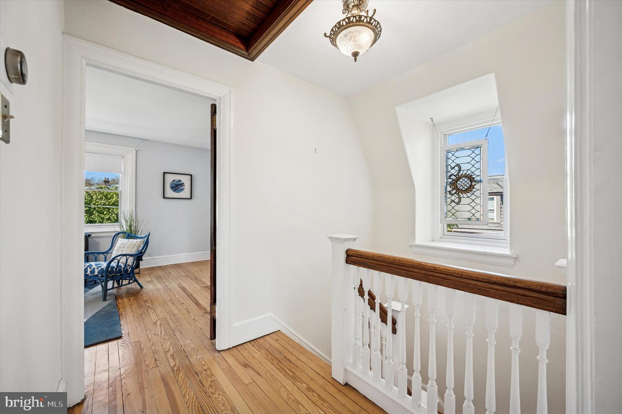 200 East Gravers Lane Philadelphia, PA 19118 - Photo 37 of 57 a view of a hallway to a livingroom with wooden floor and furniture