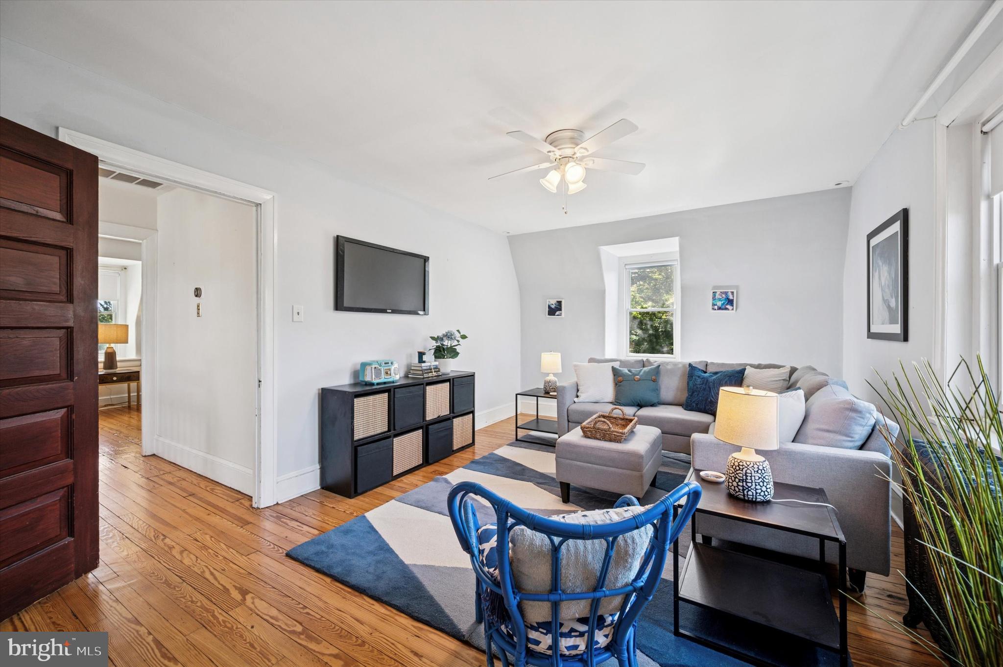 200 East Gravers Lane Philadelphia, PA 19118 - Photo 39 of 57 a living room with furniture a wooden floor and a bookshelf