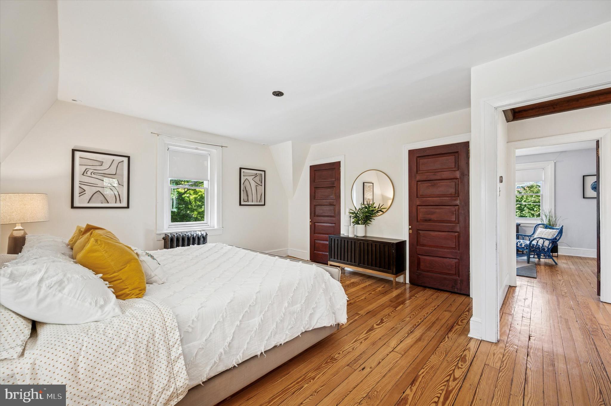 200 East Gravers Lane Philadelphia, PA 19118 - Photo 43 of 57 a bedroom with a bed and wooden floor