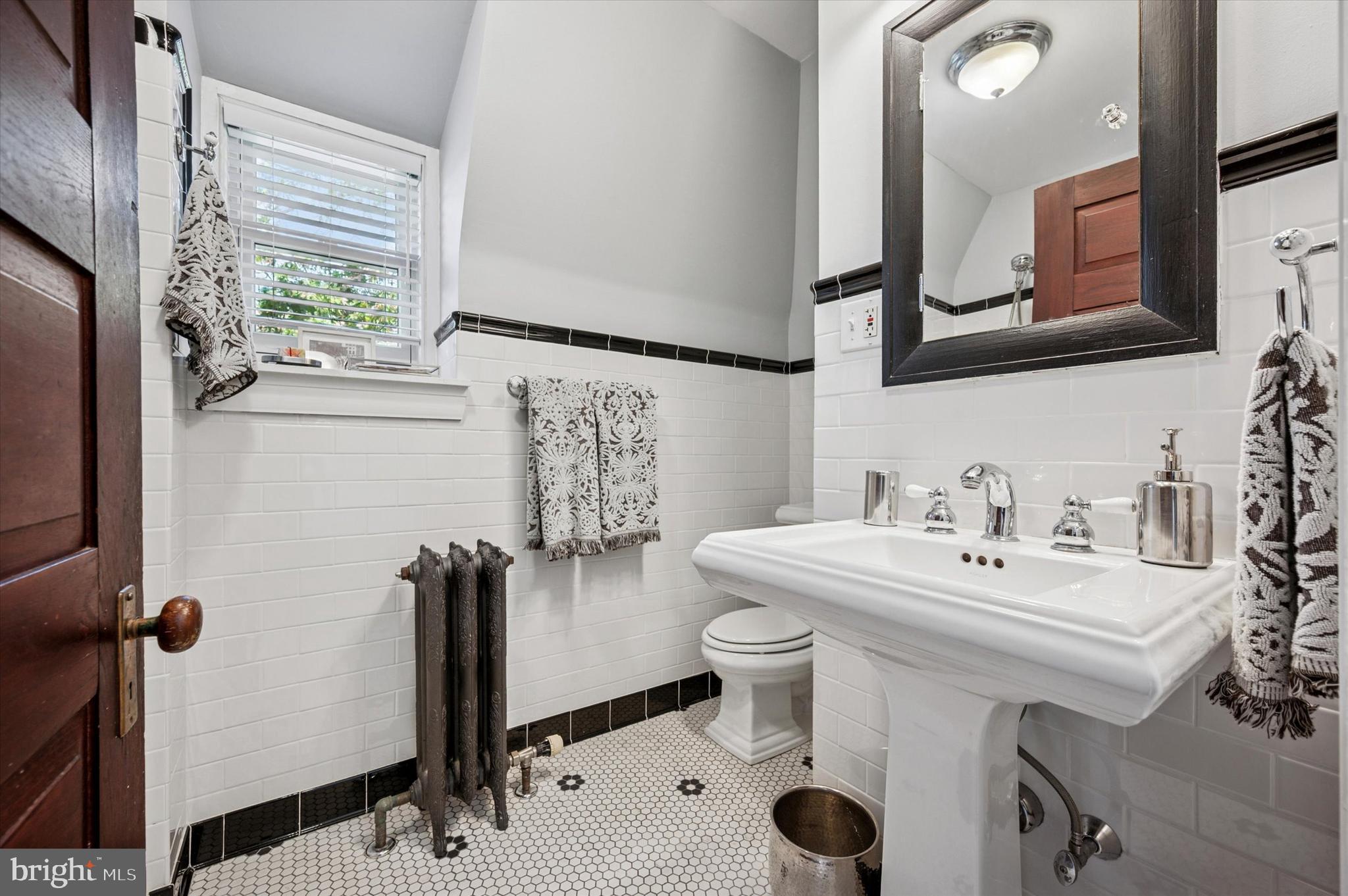 200 East Gravers Lane Philadelphia, PA 19118 - Photo 45 of 57 a bathroom with a sink mirror and window