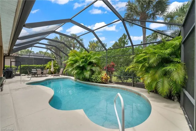 a view of a swimming pool with a patio and a garden