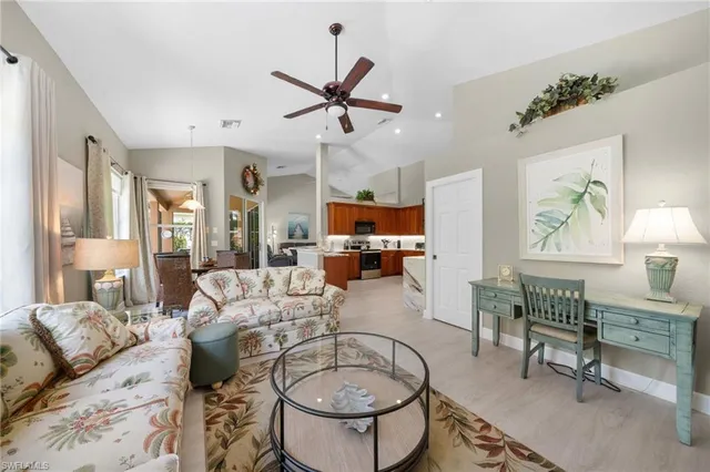 a living room with furniture a rug and a chandelier
