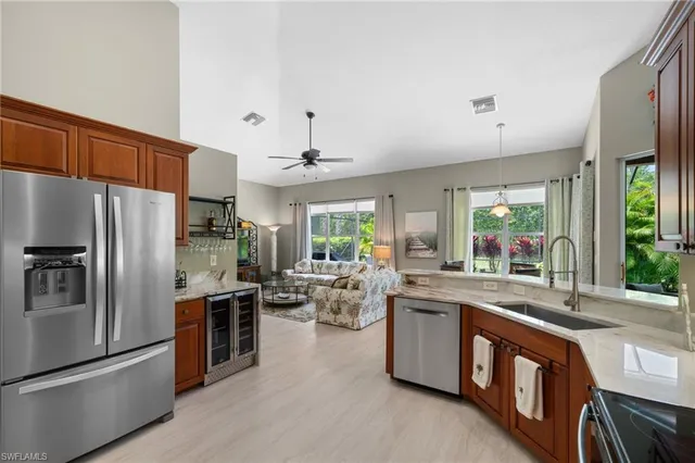 a kitchen with stainless steel appliances granite countertop a stove a sink a refrigerator and a refrigerator