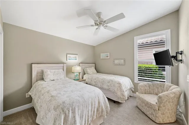 a bedroom with two beds and a couch