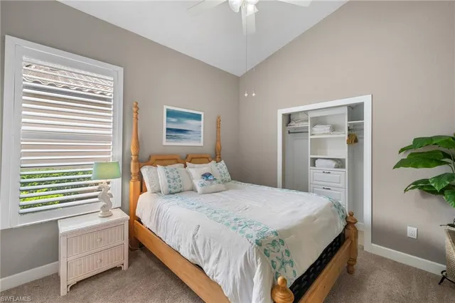 a bedroom with a bed and a potted plant