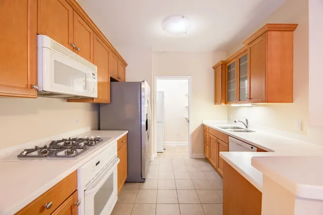 a kitchen with a sink a stove and refrigerator