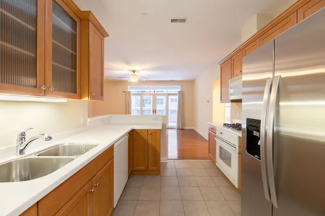 a kitchen with granite countertop a refrigerator and a sink