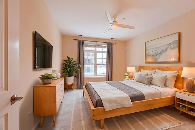 a bedroom with a bed and wooden floor