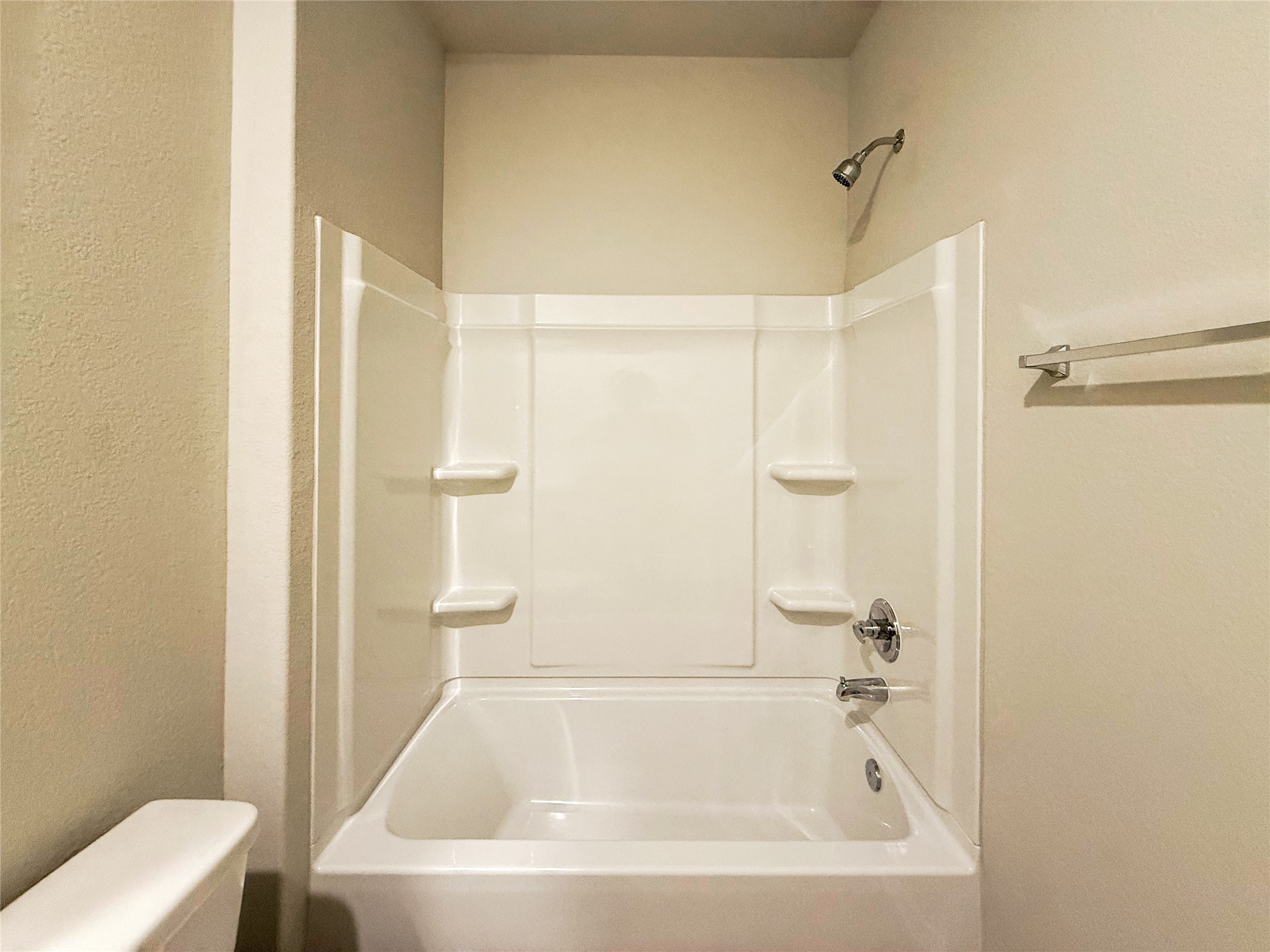 2714 Towy Road Manor, TX 78653 - Photo 15 of 22 A well-maintained tub and shower combination with clean white finishes, ready for daily refreshment.