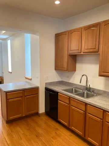 a kitchen with stainless steel appliances granite countertop a sink dishwasher stove and cabinets