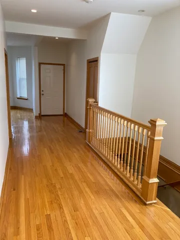 a view of a room with wooden floor and stairs