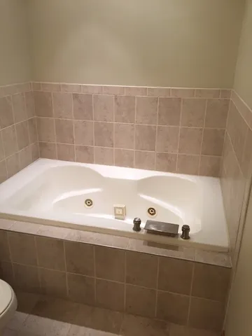 a bathroom with a bathtub and shower