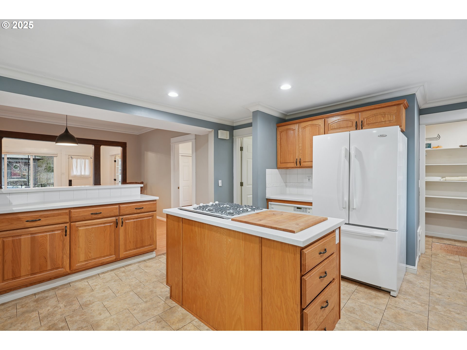 7521 North Jersey Street Portland, OR 97203 - Photo 16 of 18 a kitchen that has a sink a stove top oven a refrigerator with white cabinets and wooden floor