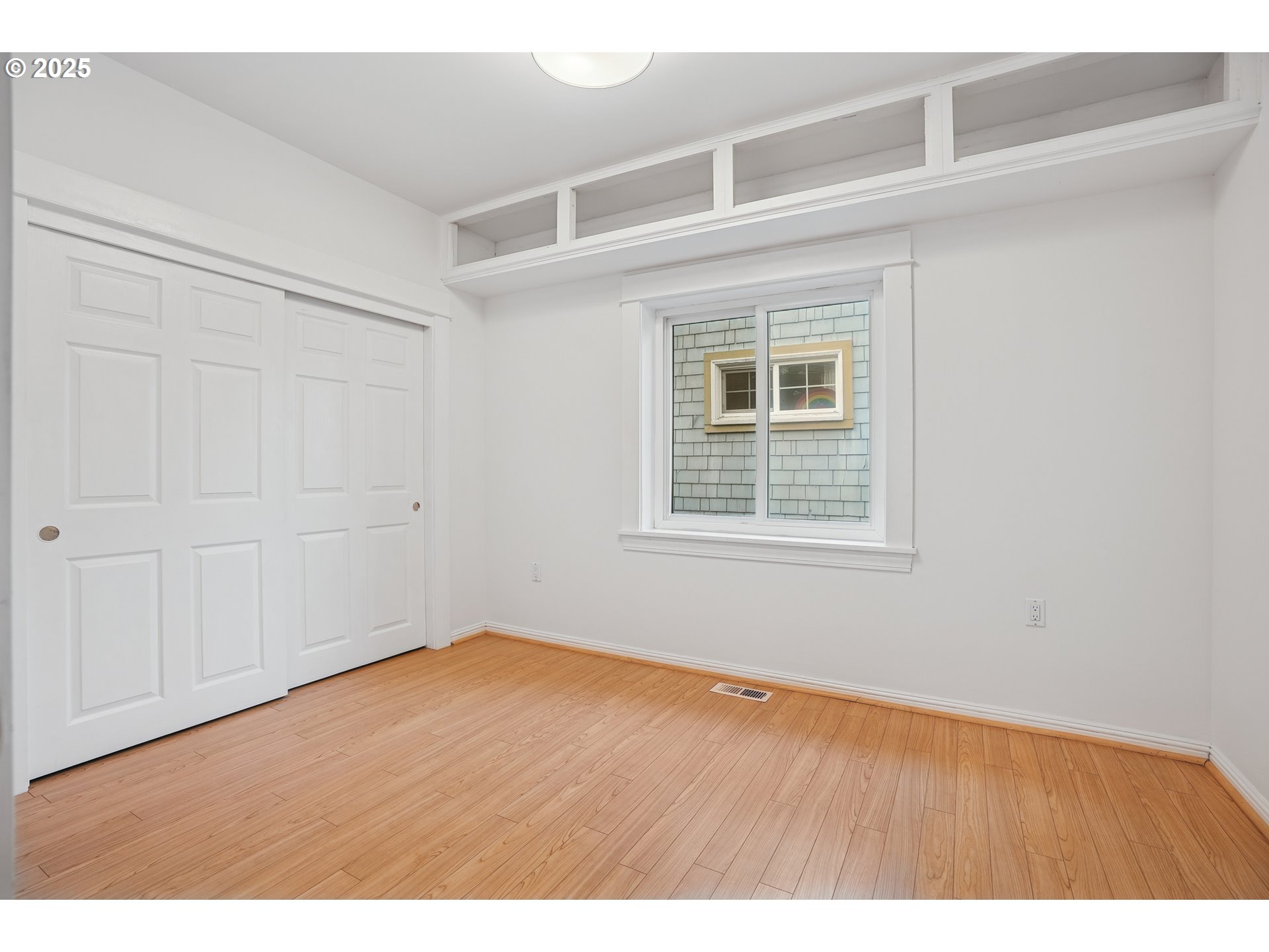 7521 North Jersey Street Portland, OR 97203 - Photo 10 of 18 a view of an empty room with wooden floor and windows