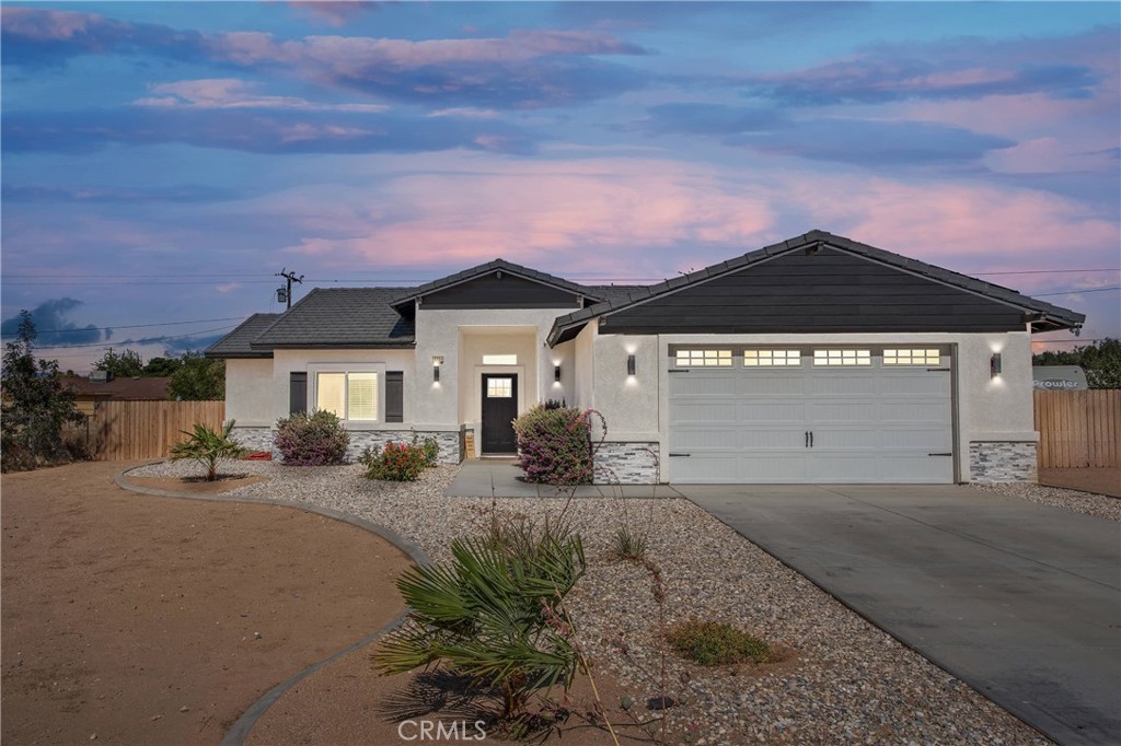 12207 Snapping Turtle Road Apple Valley, CA 92308 - Photo 1 of 1 a front view of a house with a yard and garage
