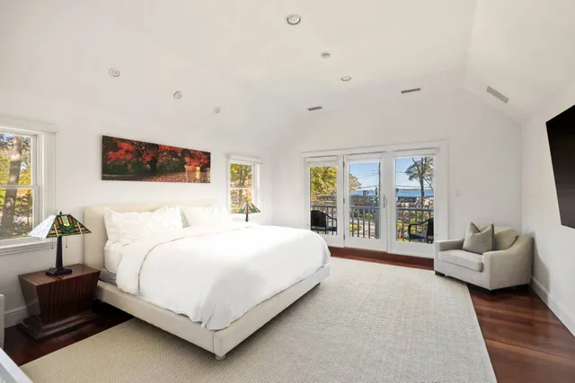 a spacious bathroom with a tub sink and mirror