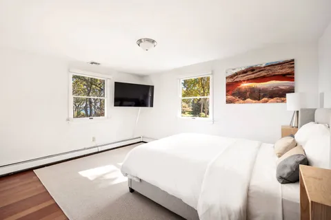 a bedroom with two beds and a desk