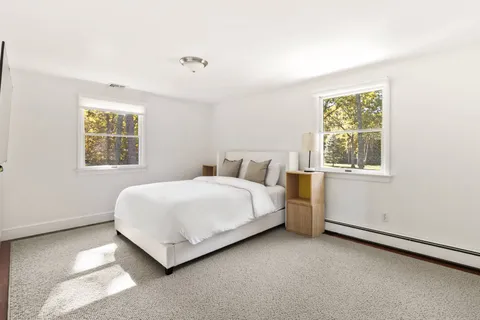 a bathroom with a granite countertop sink a mirror and a shower