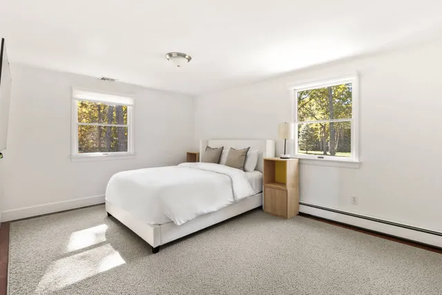 a bathroom with a granite countertop sink a mirror and a shower