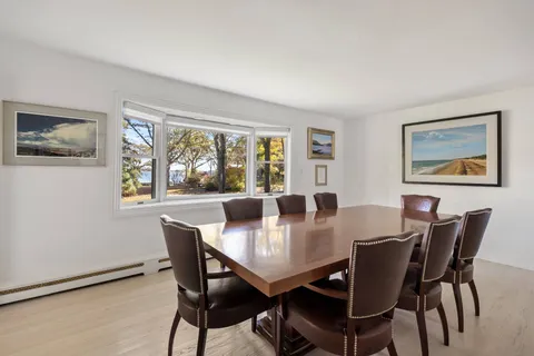 a view of a dining room with furniture and windows