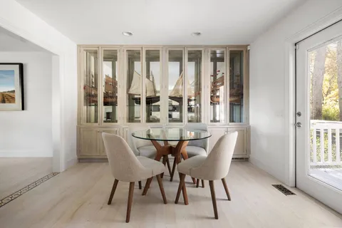 a large white kitchen with a large window