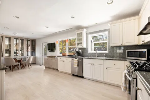 a spacious bedroom with a bed couch and a large window