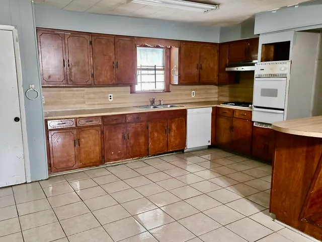 a kitchen with stainless steel appliances granite countertop a refrigerator and sink