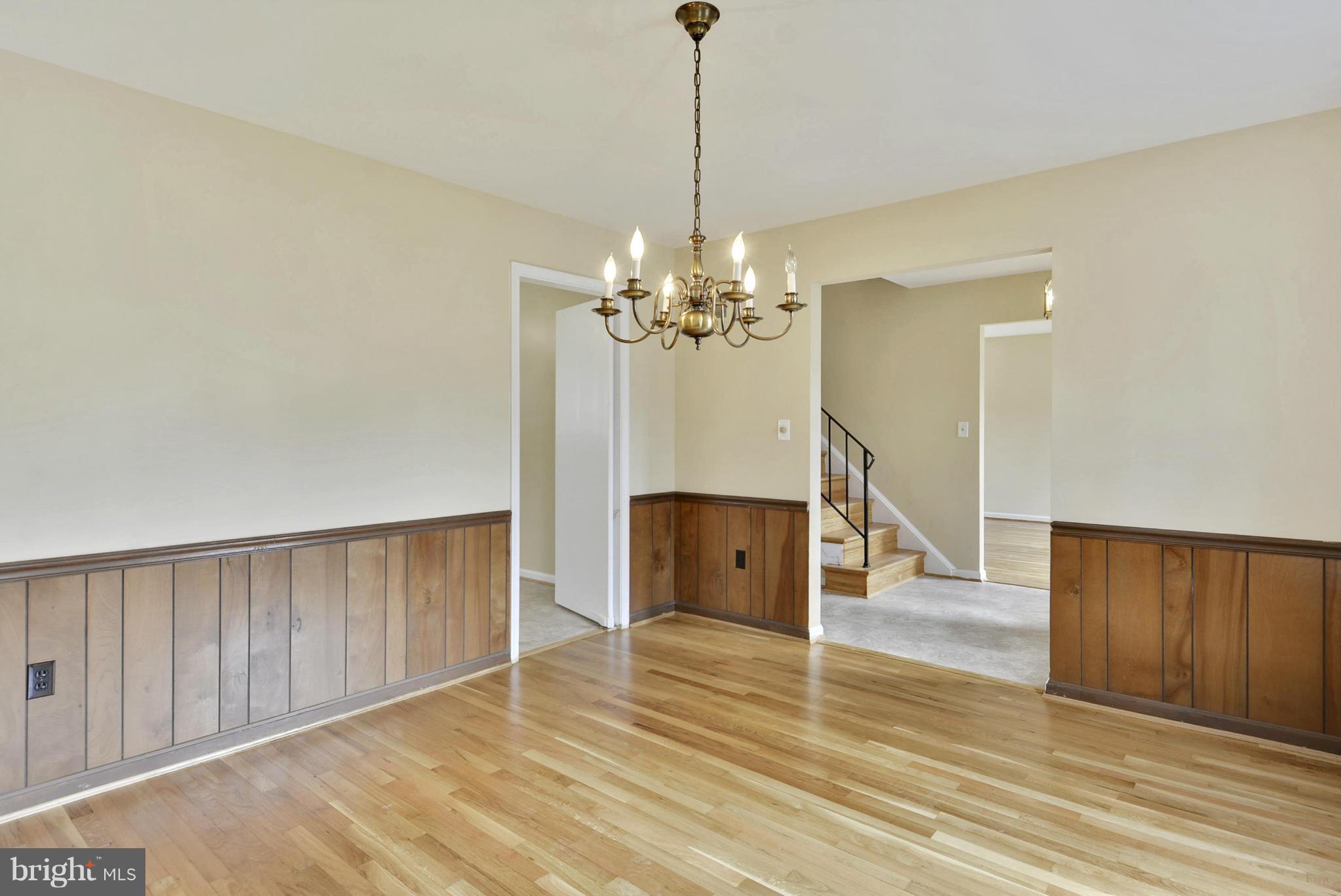 9503 Flower Avenue Silver Spring, MD 20901 - Photo 14 of 30 a view of a room with wooden floor and chandelier