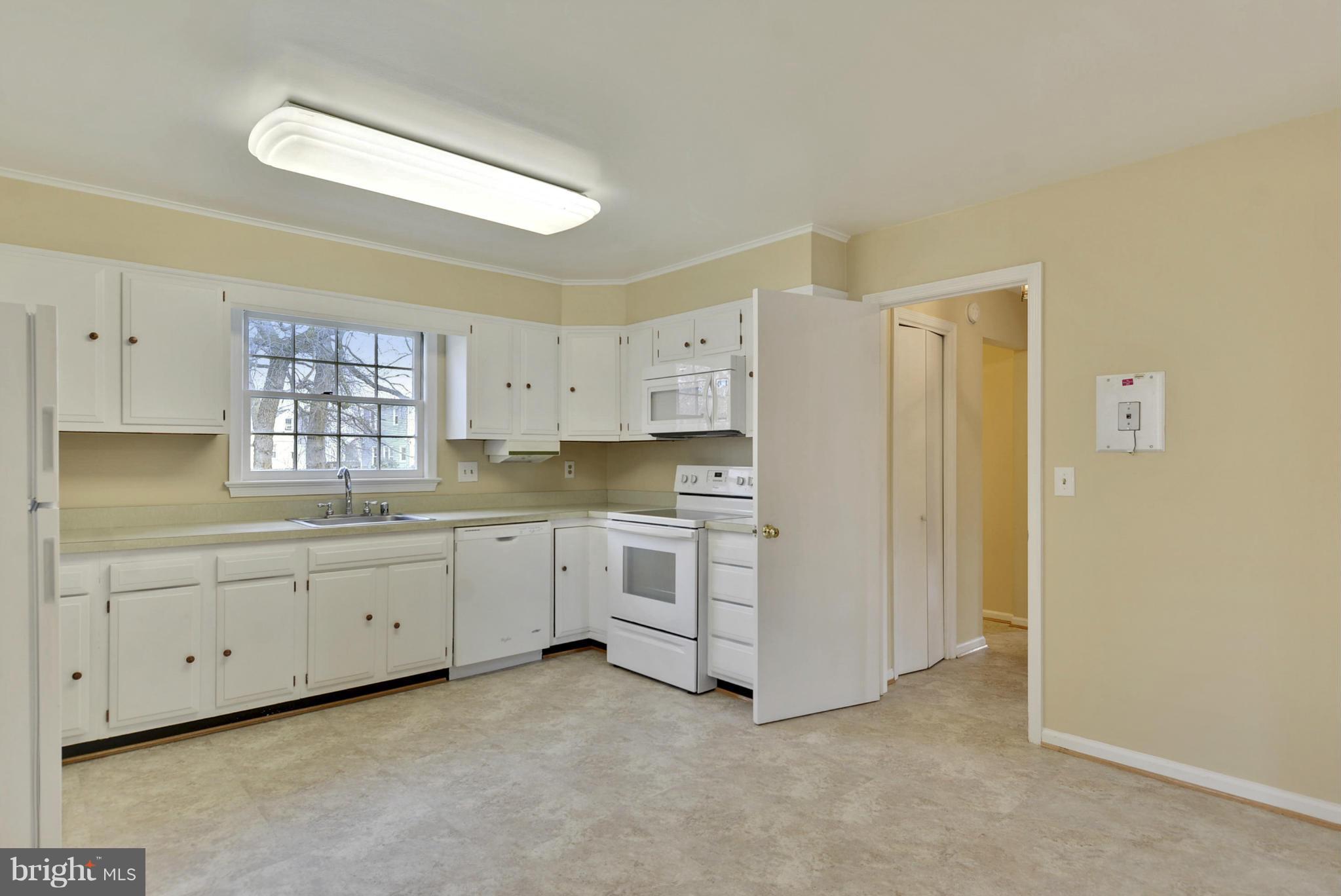 9503 Flower Avenue Silver Spring, MD 20901 - Photo 15 of 30 a kitchen with white cabinets and white appliances