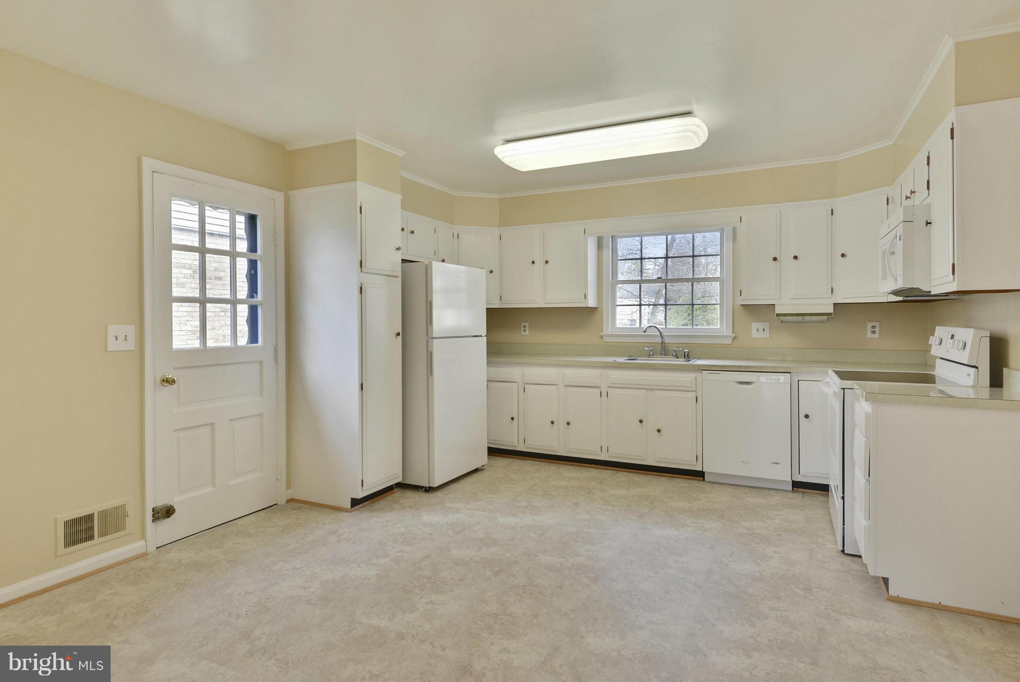 9503 Flower Avenue Silver Spring, MD 20901 - Photo 16 of 30 a view of a kitchen with refrigerator and window