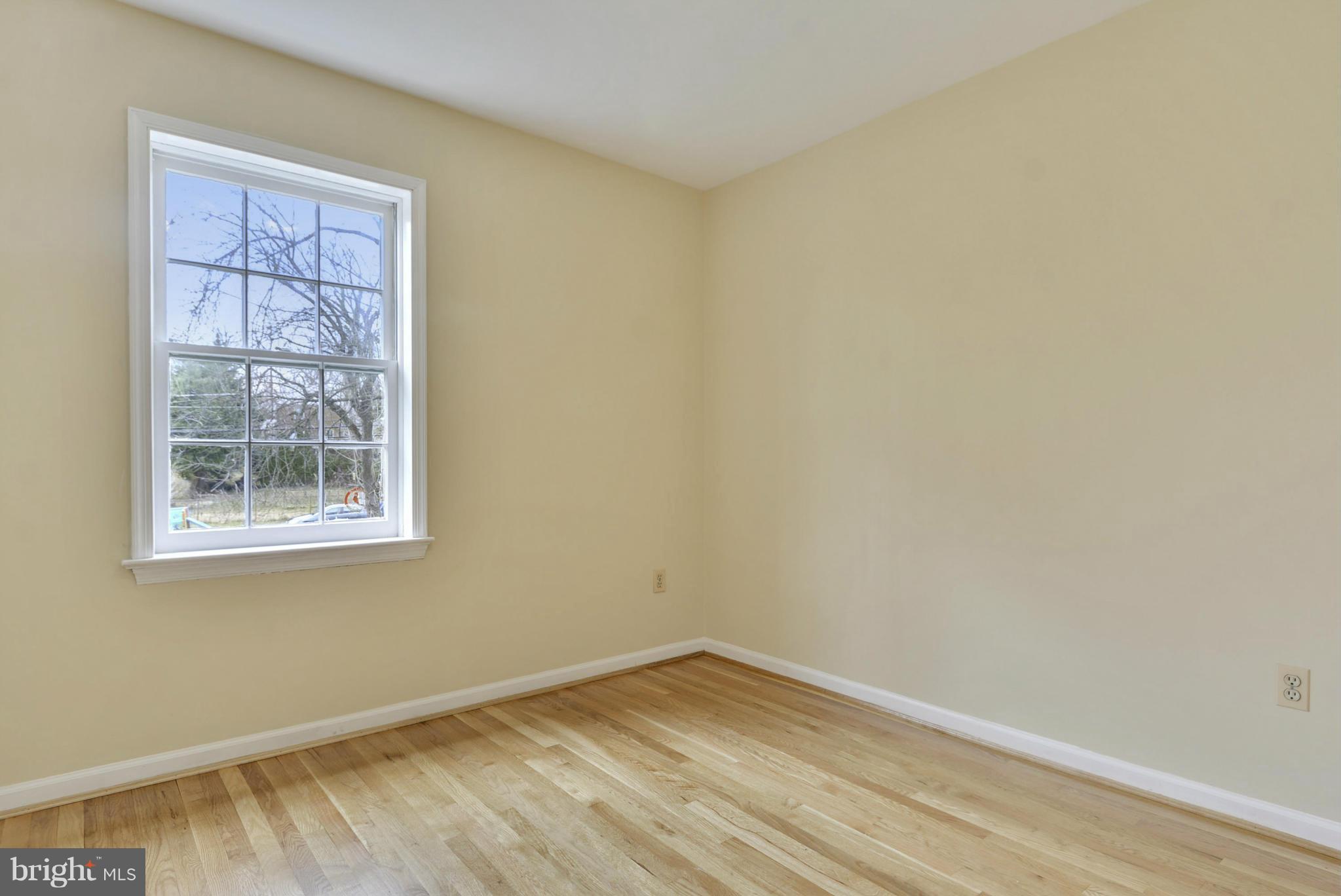 9503 Flower Avenue Silver Spring, MD 20901 - Photo 19 of 30 a view of an empty room with wooden floor and a window