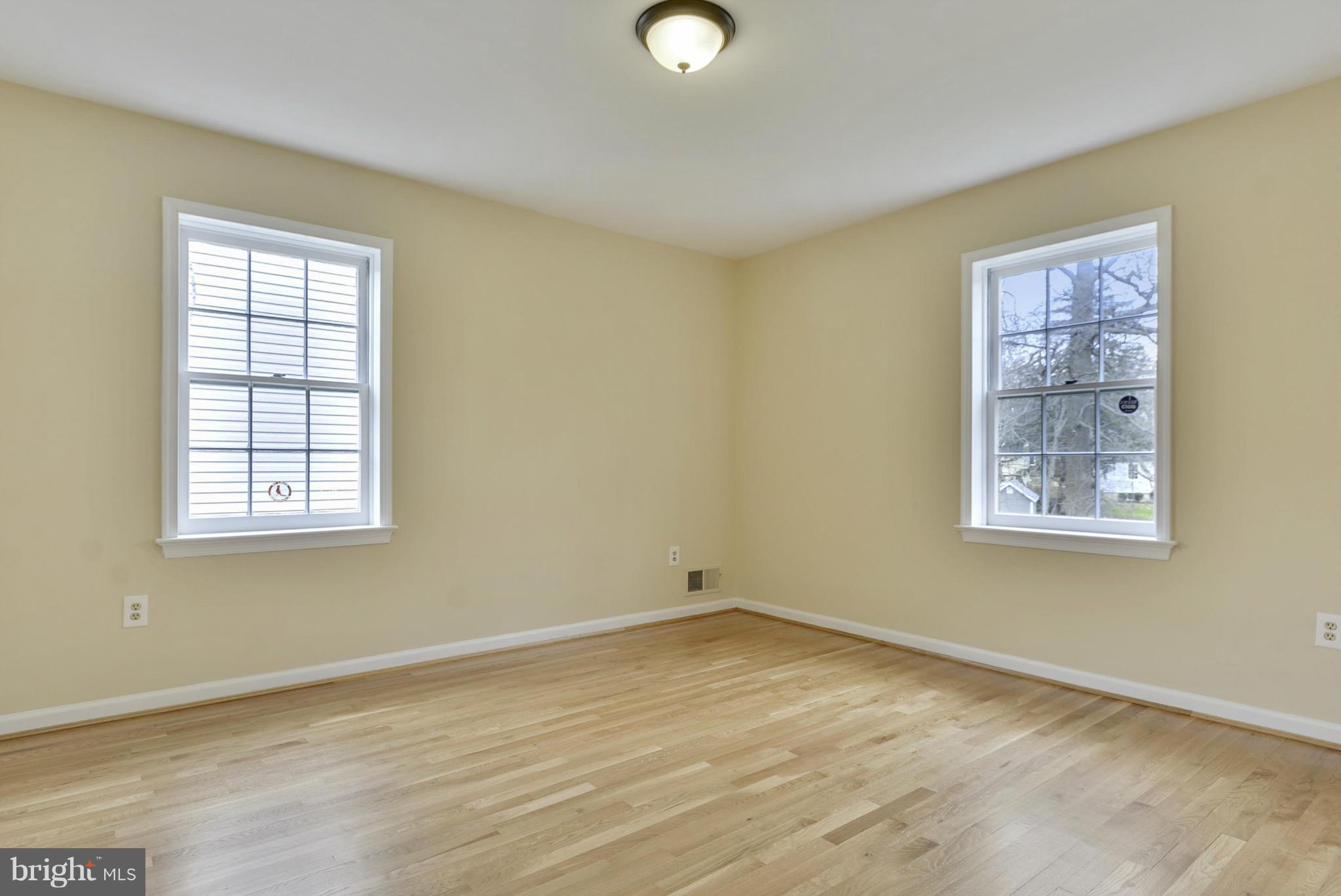 9503 Flower Avenue Silver Spring, MD 20901 - Photo 21 of 30 a view of an empty room with wooden floor and a window