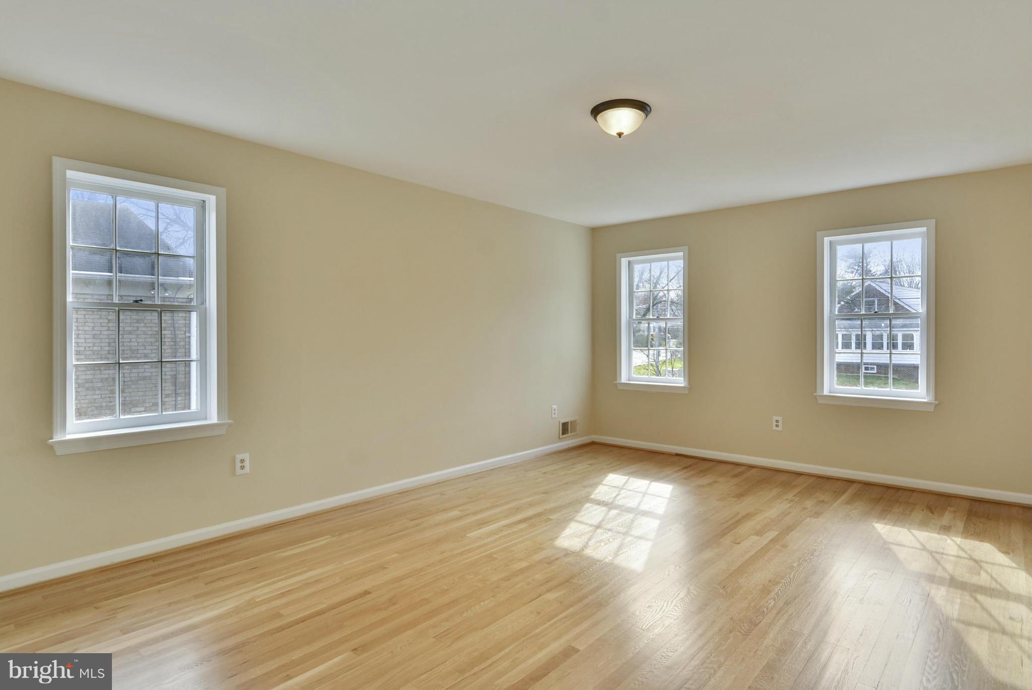 9503 Flower Avenue Silver Spring, MD 20901 - Photo 25 of 30 a view of an empty room with wooden floor and a window