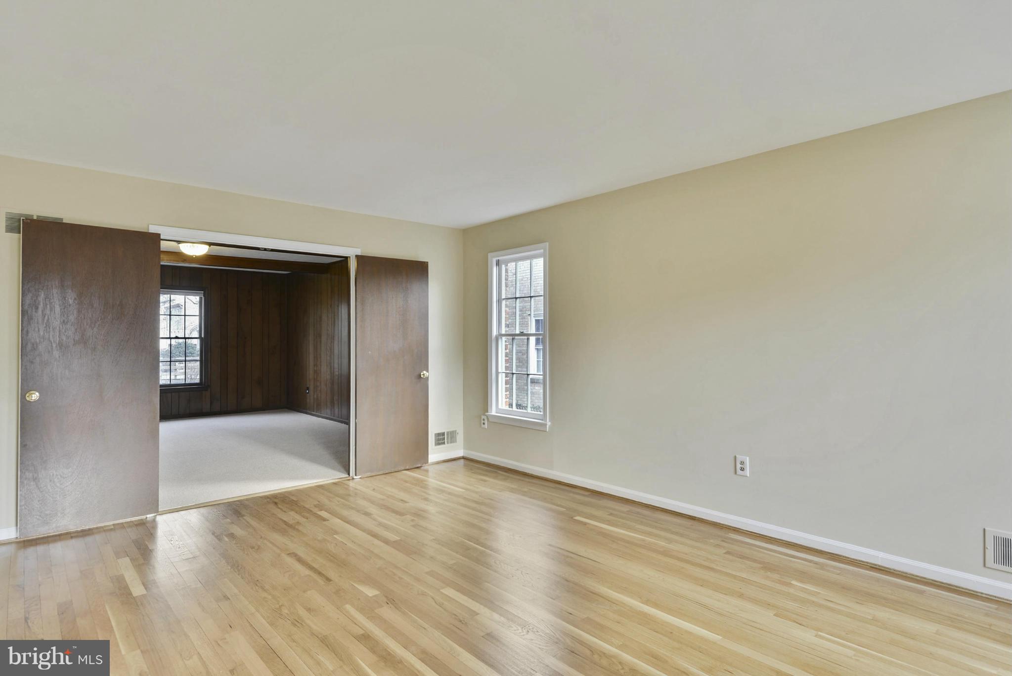 9503 Flower Avenue Silver Spring, MD 20901 - Photo 8 of 30 a view of an empty room with wooden floor and a window